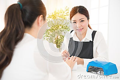 Nail salon worker giving a manicure Stock Photo