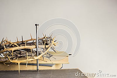 A nail, thorn crown with nail and Bible on a light background Stock Photo