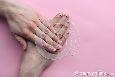 Nails after gel Polish. the concept of nails before the manicure.untidy hands on pink background Stock Photo