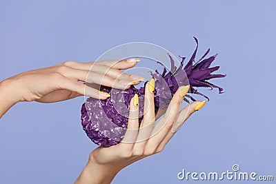 Nails Manicure. Hand With Stylish Nails Holding Purple Pineapple Stock Photo