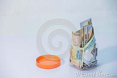 Naira notes in a glass jar - concept of Saving Stock Photo