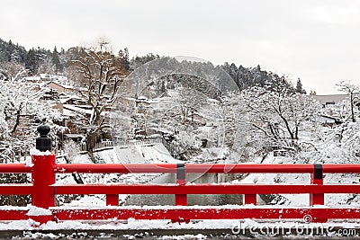 Nakabashi Bridge with snow fall and Miyakawa river in winter season . Landmark of Hida , Gifu , Takayama , Japan . Landscape view Stock Photo