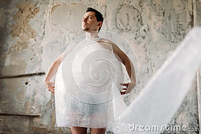 Naked freak man wrapped in packaging film Stock Photo