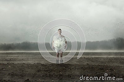 Freak man stands in the middle of the field Stock Photo