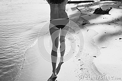 Naked lady walks along sea shore monochrome scenic photography Stock Photo