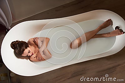 Woman in bath of milk Stock Photo