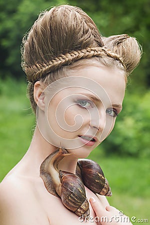 Naked young woman with fashion hairstyle and two big snails Stock Photo