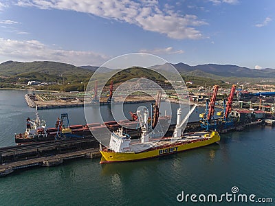 Nakhodka, Russia - May 16, 2017: Bulk carrier GNS Hore and vessel for transportation of large cargoes Happy Sky are in the port ne Editorial Stock Photo