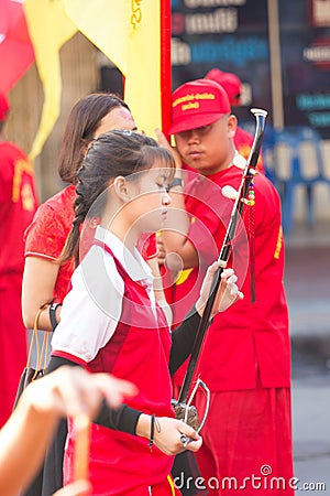 NAKHON SAWAN, THAILAND - FEBRUARY 8 : unidentified asian female student playing fiddle at parade in Chinese New Year festival on Editorial Stock Photo