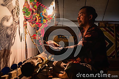 Thai shadow puppet performance artist playing Nang Thalung Thai traditional shadow puppet show Editorial Stock Photo