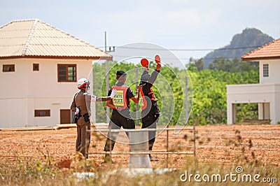 Police marshaller is Marshalling signals to Helicopter Landing at Field Editorial Stock Photo