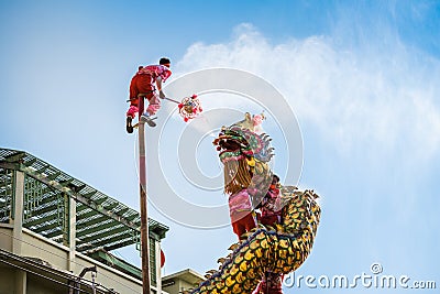Nakhonsawan Thailand-Feb 4, 2022; Performance of dragon dance on pole. Dragon mule crystal ball. Editorial Stock Photo