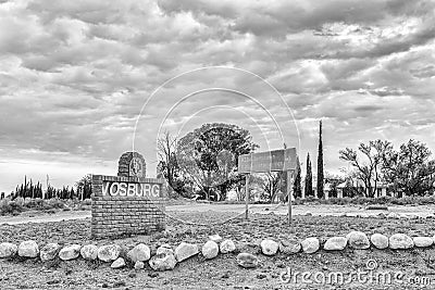 Name board and directional sign at entrance to Vosburg. Monochrome Editorial Stock Photo