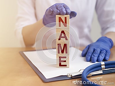 NAME word on wooden block in doctor hand Stock Photo