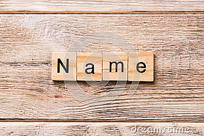 NAME word written on wood block. NAME text on wooden table for your desing, concept Stock Photo