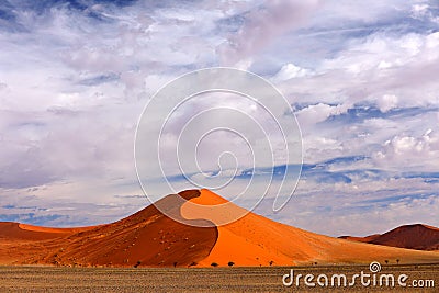 Namibia landscape. Big orange dune with blue sky and clouds, Sossusvlei, Namib desert, Namibia, Southern Africa. Red sand, biggest Stock Photo