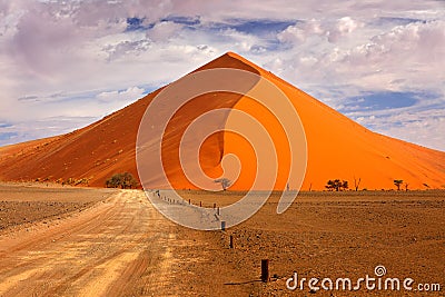 Namibia landscape. Big orange dune with blue sky and clouds, Sossusvlei, Namib desert, Namibia, Southern Africa. Red sand, biggest Stock Photo