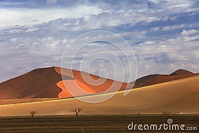 Namibia landscape. Big orange dune with blue sky and clouds, Sossusvlei, Namib desert, Namibia, Southern Africa. Red sand, biggest Stock Photo