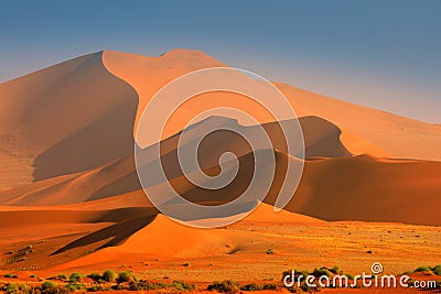 Namibia landscape. Big orange dune with blue sky and clouds, Sossusvlei, Namib desert, Namibia, Southern Africa. Red sand, biggest Stock Photo