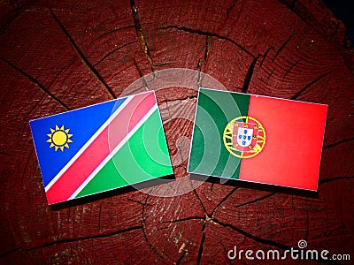 Namibian flag with Portuguese flag on a tree stump isolated Stock Photo