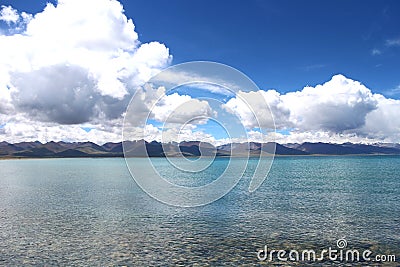 Namtso lake with distant mountains and blue sky in Tibet, China Stock Photo