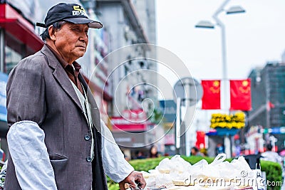 Nantong City / China - October 3, 2011 : Portrait of mature aged Asian Chinese man. He sells street snacks Editorial Stock Photo