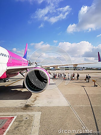Big white purple and blue aeroplane of Wizzair on airport Editorial Stock Photo