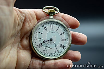 Gold pocket watch from the early 1900s. The case with Roman numerals is visible. Editorial Stock Photo