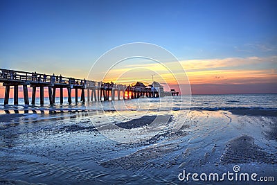 Naples Pier on the beach at sunset Stock Photo