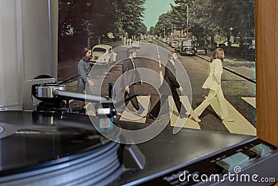 Naples, record player with the Beatles vinyls Abby Road on background. Editorial Stock Photo