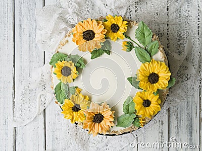 Napoleon cake with vanilla cream, decorated with buttercream flowers - sunflowers. Vintage style. Wooden background,lace Stock Photo