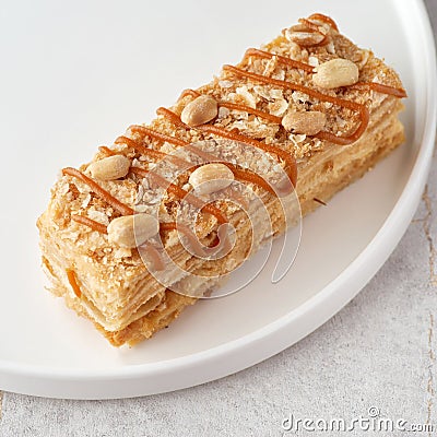 Napoleon salted caramel cake. Delicate and delicious homemade puff pastry dessert with custard. Close up. Stock Photo