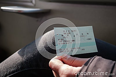 NARA, JAPAN - JAN 30, 2018: Person holding a JR Rails train ticket from Nara to Tennoji Editorial Stock Photo