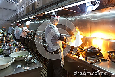 A narrow aisle, working chef. Editorial Stock Photo