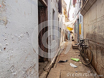 A narrow alley with a parked bicycle Editorial Stock Photo