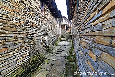 Narrow alley between stone houses Stock Photo