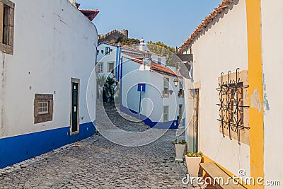 Narrow cobbled street in Obidos village, Portug Stock Photo