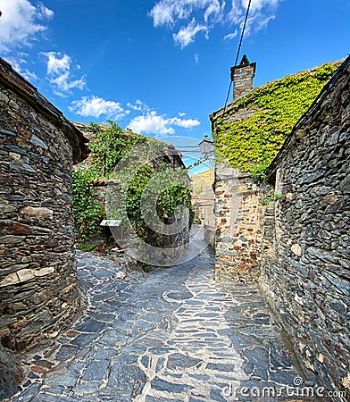 Narrow cobbled street with stone houses Stock Photo