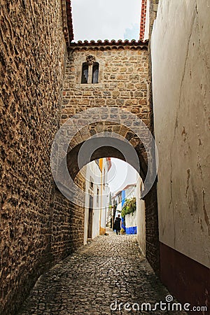 Narrow and colorful streets, facades and balconies of Obidos Editorial Stock Photo