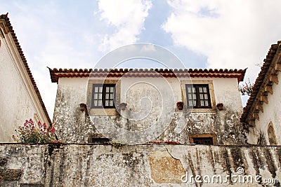 Narrow and colorful streets, facades and balconies of Obidos Stock Photo