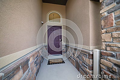 Narrow concrete entrance of a house with a security camera Stock Photo