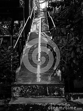 Narrow concrete walkway ramp up to higher floor, black and white style Stock Photo