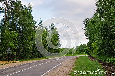 Narrow country road near a forest Stock Photo