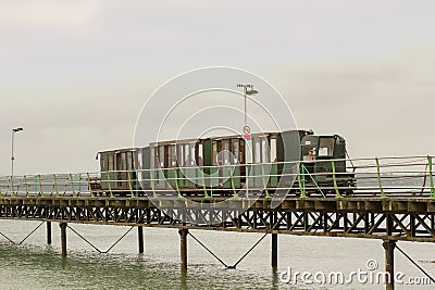 The narrow gauge train that runs the length of the Hythe Pier carrying passengers to and from the ferry boat to Southampton taken Stock Photo