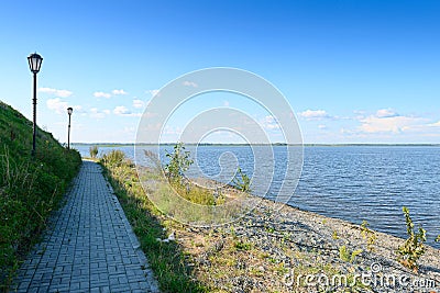 A path with lanterns along the river bank Stock Photo