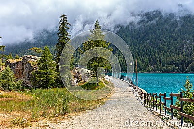 Narrow pathway along Lago di Ceresole in Italy. Stock Photo