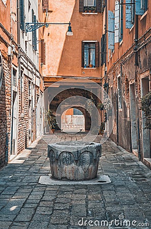 Narrow pedestrian cobblestone old alleys in Venice, Italy. Old worn out medieval buildings Stock Photo