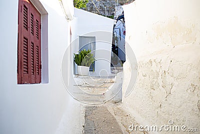 Narrow pedestrian street with stairs and white clay walls in Plaka district, Athens, Greece Stock Photo