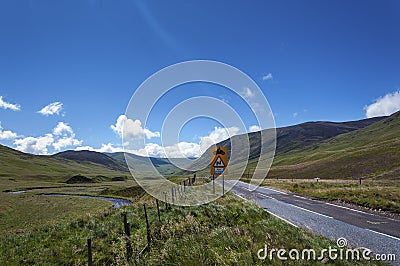 Narrow road along a valley in the Scottish Highlands in Scotland, United Kingdom Stock Photo