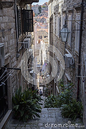 Narrow and steep street in Dubrovnik, formerly Ragusa, city located on the Dalmatian coast, Croatia Editorial Stock Photo